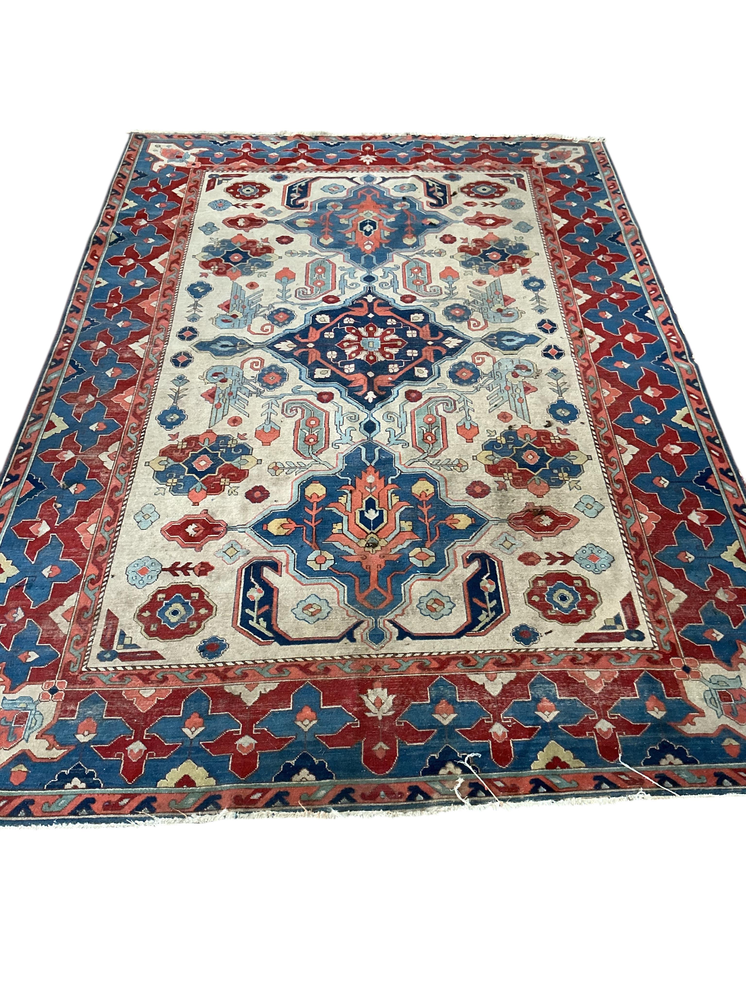 A Persian ivory ground Shirvan style carpet, approximately 300 x 198cm